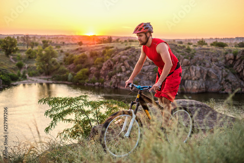 Fototapeta Naklejka Na Ścianę i Meble -  Cyclist riding on the rocks, free space.