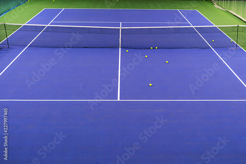 empty blue and green hard tennis court with balls, top view