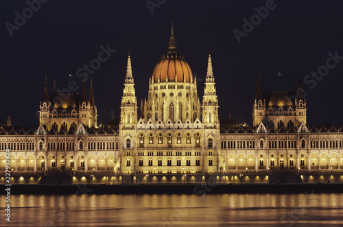 Night view of the illuminated building of the hungarian parliament in Budapest. A beautiful reflection of the parliament building on the Danube River. Winter city night landscape. © Della_Liner
