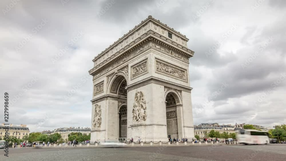 The Arc de Triomphe, one of the most famous landmarks of Paris. Car traffic in traffic circle. Dark clouds move across the sky. Time lapse video The Arc de Triomphe, one of the most famous landmarks of Paris. Car traffic in traffic circle. Dark clouds move across the sky. Time lapse video