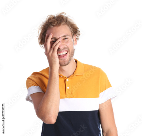 Handsome young man laughing on white background