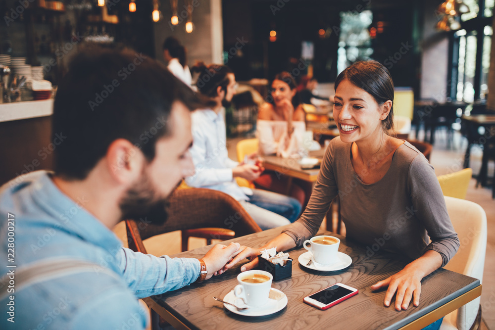 Young happy couple at a date in a coffee shop Young happy couple at a date in a coffee shop