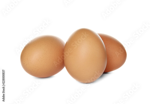 Raw brown chicken eggs on white background