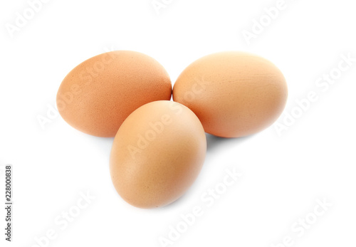 Raw brown chicken eggs on white background