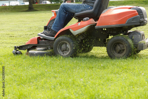 lawn mower tractor working in the town park