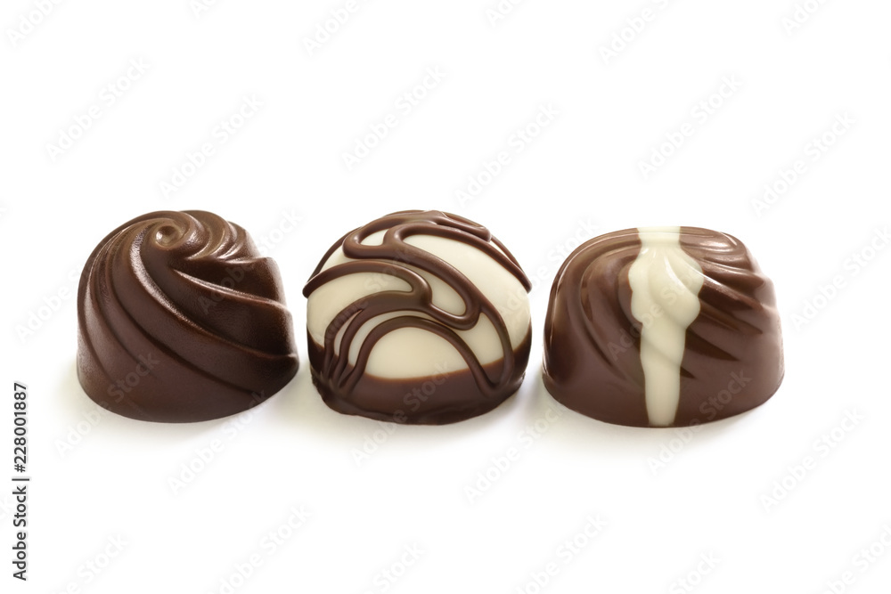 Fototapeta premium Assortment of chocolate candies from black, milk and white chocolate with nuts and marzipan