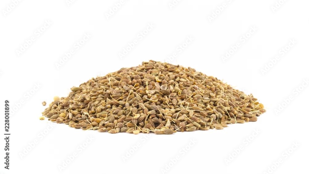 Pile of anise seeds. Rotating on the turntable. Isolated on the white background. Close up. Macro. Pile of anise seeds. Rotating on the turntable. Isolated on the white background. Close up. Macro.