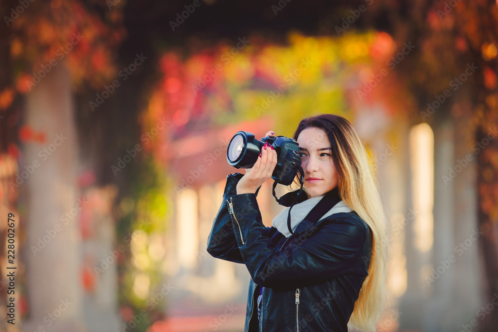 Young girl in jaсket with camerain red grapes alley. Autumn season time Young girl in jaсket with camerain red grapes alley. Autumn season time