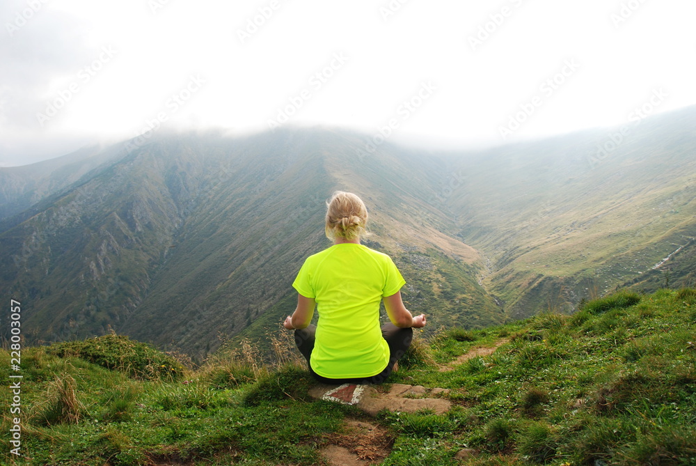 A woman meditating in Carpathian Mountains, Transylvania, Romania