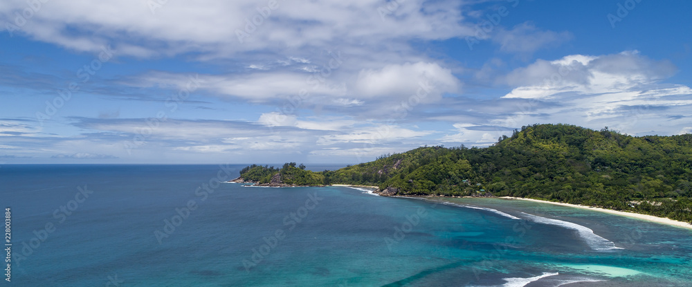 Tropical beach with sea and palm taken from drone. Beach and sea photo. Romantic beach aerial view.
