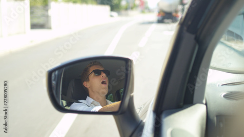 SLOW MOTION: Angry Caucasian man throwing a temper tantrum while driving to work