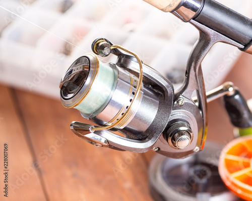 Spinning reel on the background of fishing gear. Close-up