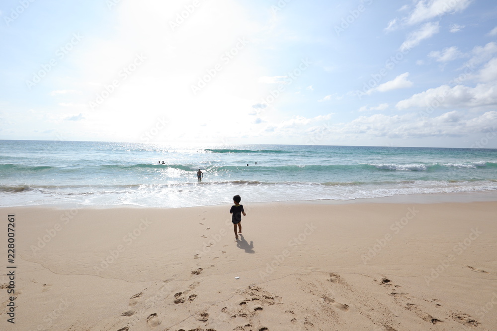 boy stand on the beach