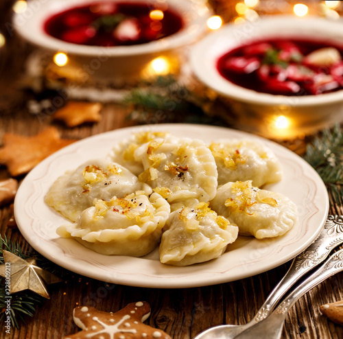 Christmas dumplings stuffed with mushroom and cabbage on a white plate. Traditional Christmas eve dish in Poland