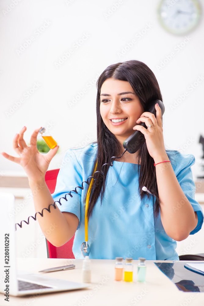 Young beautiful female doctor working in the clinic Young beautiful female doctor working in the clinic