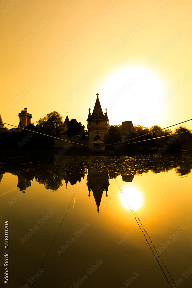 View on Franzensburg castle in Laxenburg town in Austria. Long exposure effect with glossy water and reflection.
