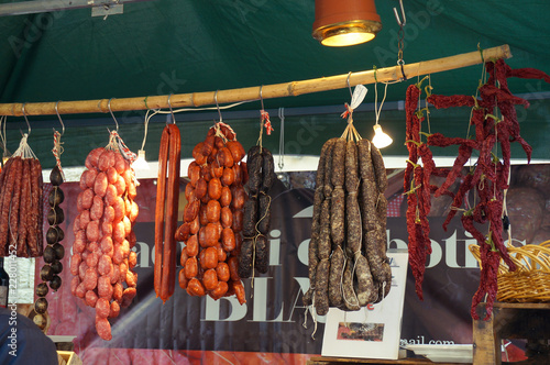 Sausages hanging in butcher shop on traditional market in Spain
