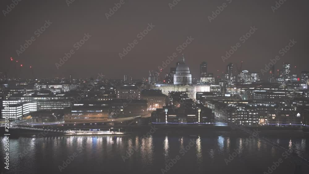 Night scene of British London still drone aerial view of Anglican St Paul's Cathedral the seat of the Bishop of London and Millennium Bridge and magical Thames river skyscrapers in the background - fa Night scene of British London still drone aerial view of Anglican St Paul's Cathedral the seat of the Bishop of London and Millennium Bridge and magical Thames river skyscrapers in the background - fa