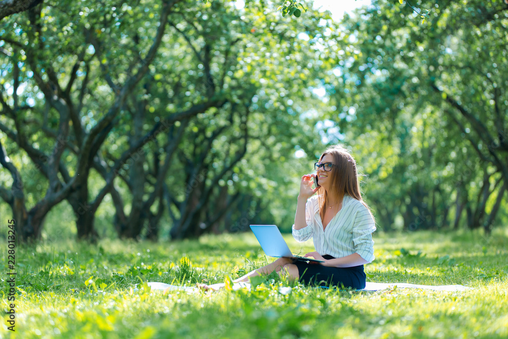 Business woman using laptop on lunch break in city park Business woman using laptop on lunch break in city park