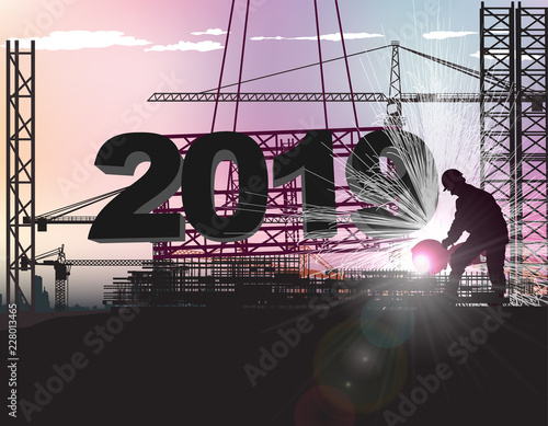 worker sets large numbers 2019 on the roof of the building under construction