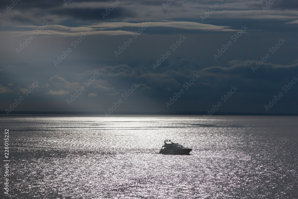 Naklejka premium lonely yacht in the sun on the sea Yachting theme