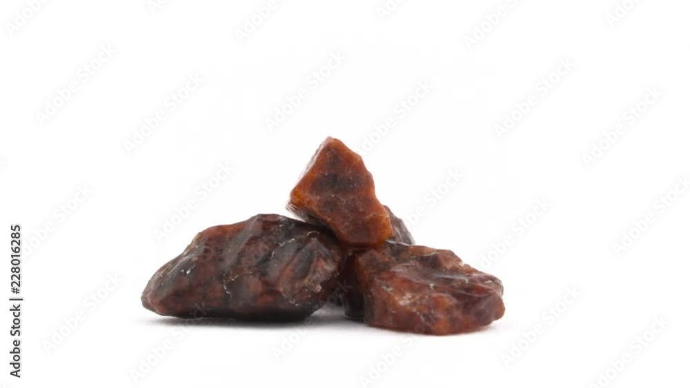 Three big Kala namak salt crystals. Brown color. Rotating. Isolated on the white background. Close up. Macro. Three big Kala namak salt crystals. Brown color. Rotating. Isolated on the white background. Close up. Macro.