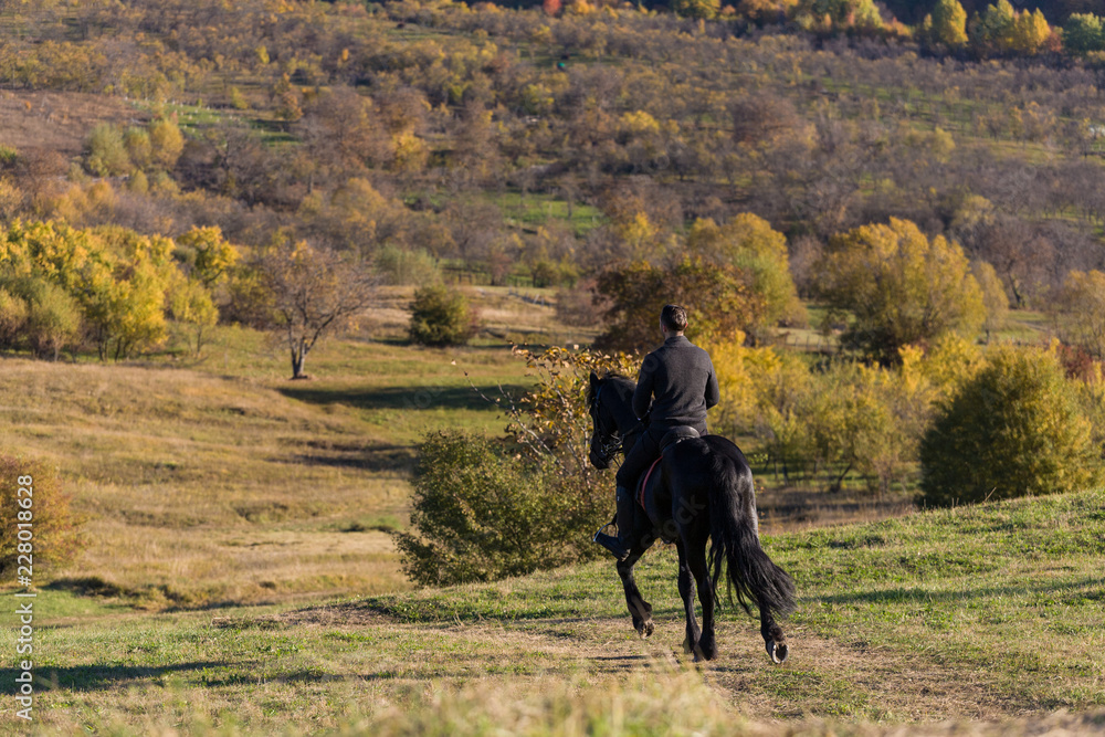 A beautiful connection between a equestrian and his black horse on a sunny autumn day. A beautiful connection between a equestrian and his black horse on a sunny autumn day.