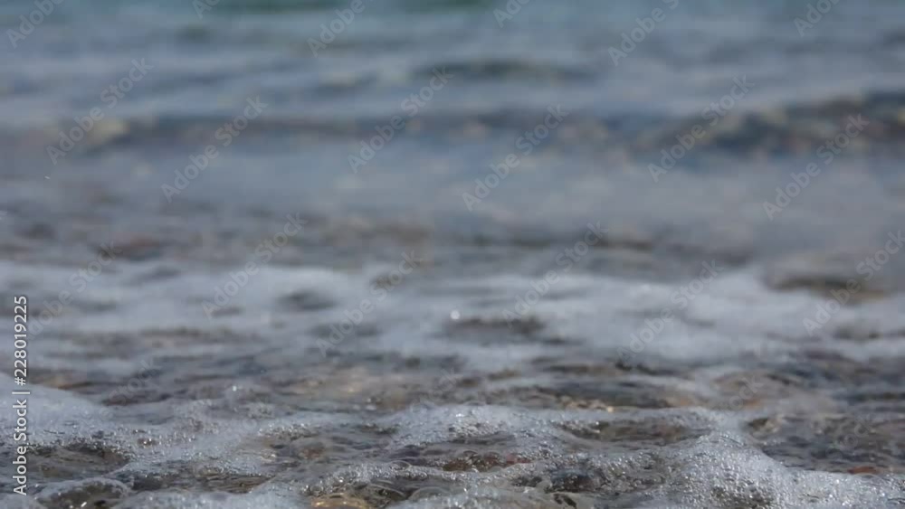Pebble beach of the sea. the waves on the shore are slow. close up. Pebble beach of the sea. the waves on the shore are slow. close up.