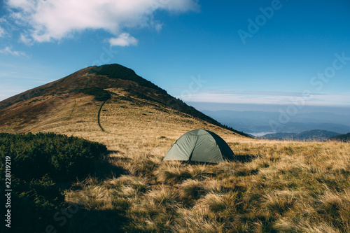 Tent high in mountains. Carpathian. Top on background
