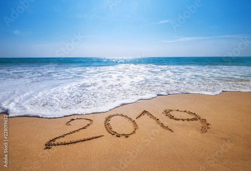 Happy New Year 2019 is coming concept sandy tropical ocean beach lettering concept image and