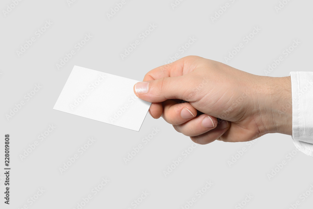 Mockup of male hand holding a Business Card isolated on light grey background. Europe standard size 85x 55 mm. Mockup of male hand holding a Business Card isolated on light grey background. Europe standard size 85x 55 mm.