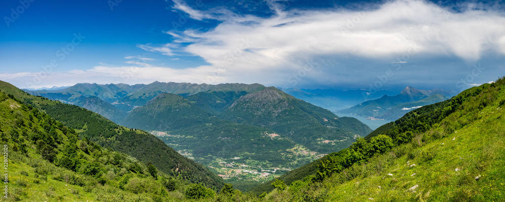 Fototapeta premium Panoramic view of Pizzo di Gino, Monte Grona, Monte Legnone, Lake Como and surrounding mountains as seen from Monte Tremezzo