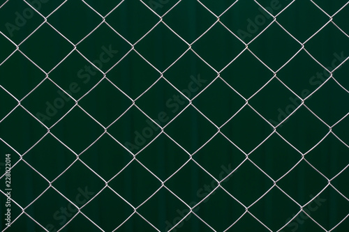 Metal grid on dark green background
