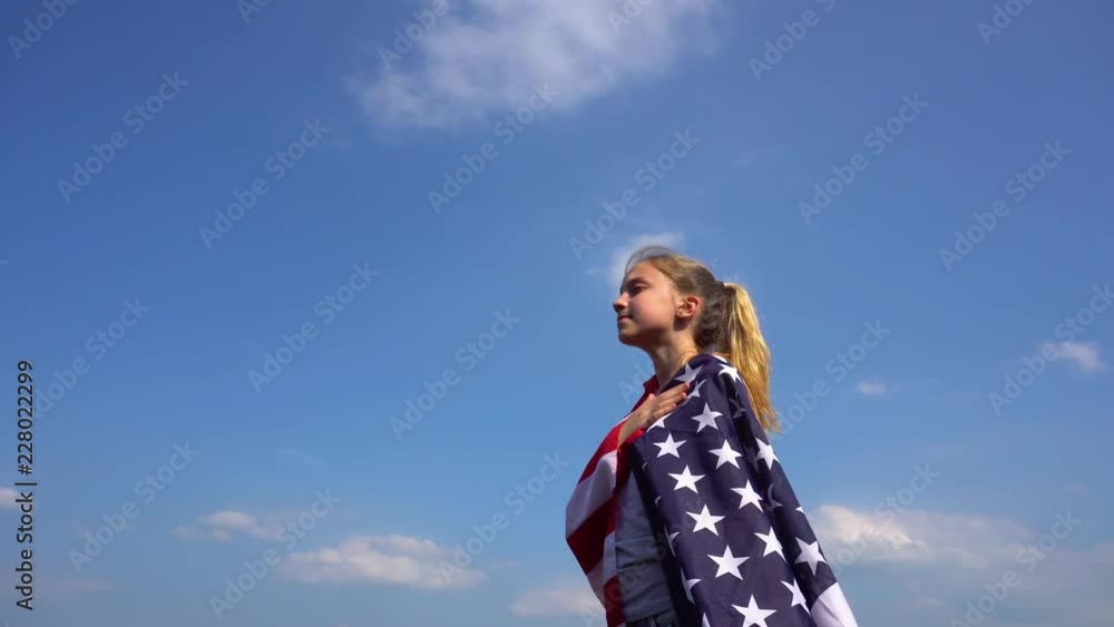 Teen patriotic woman with USA flag in nature Teen patriotic woman with USA flag in nature