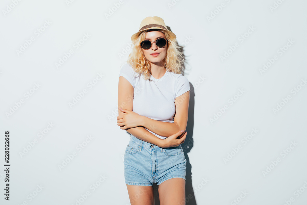 Portrait of a pretty beautiful blonde wearing beach hat on the white background Portrait of a pretty beautiful blonde wearing beach hat on the white background