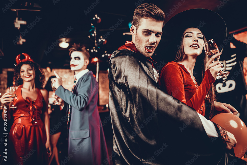 Φωτογραφία Young Happy Couple in Costumes at Halloween Party
