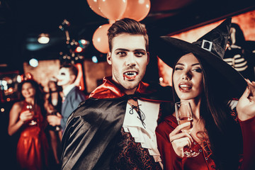 Young Happy Couple in Costumes at Halloween Party