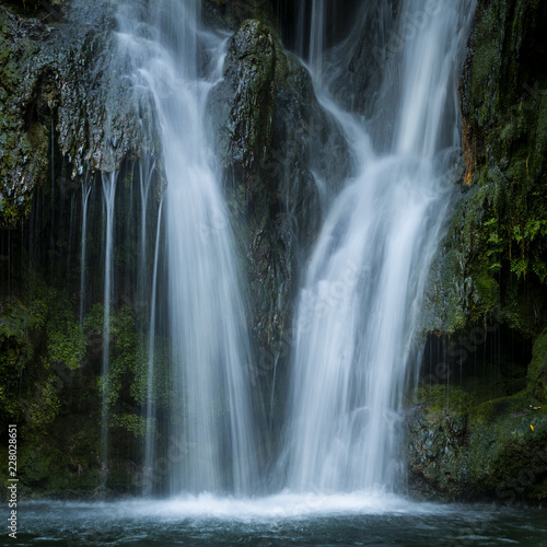 Waterfall flowing on rock in woods in long exposure