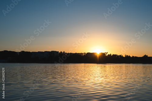 The reflection of the sunset in the lake. Background for design. © Lalandrew