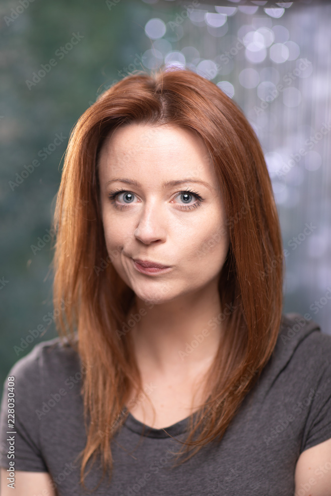 Portrait of white skin ginger girl with blue eyes with dark grey t shirt Portrait of white skin ginger girl with blue eyes with dark grey t shirt
