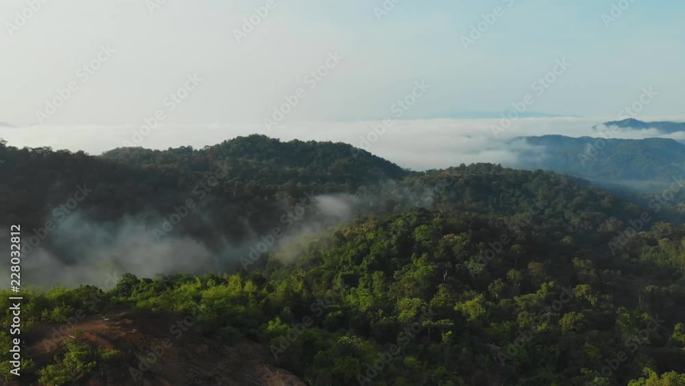 Landscape of Morning Mist with Mountain Layer at north of Thailand. Aerial View. Flying over the high mountains in beautiful clouds . Aerial camera shot. Landscape of Morning Mist with Mountain Layer at north of Thailand. Aerial View. Flying over the high mountains in beautiful clouds . Aerial camera shot.