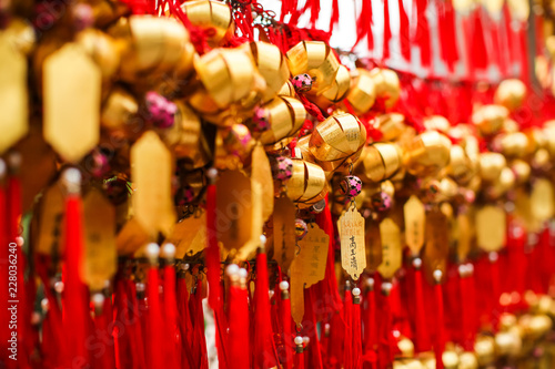 Close up rows Devotees hanging golden prayer bells for blessing at at Wong Tai Sin Temple  Hong Kong