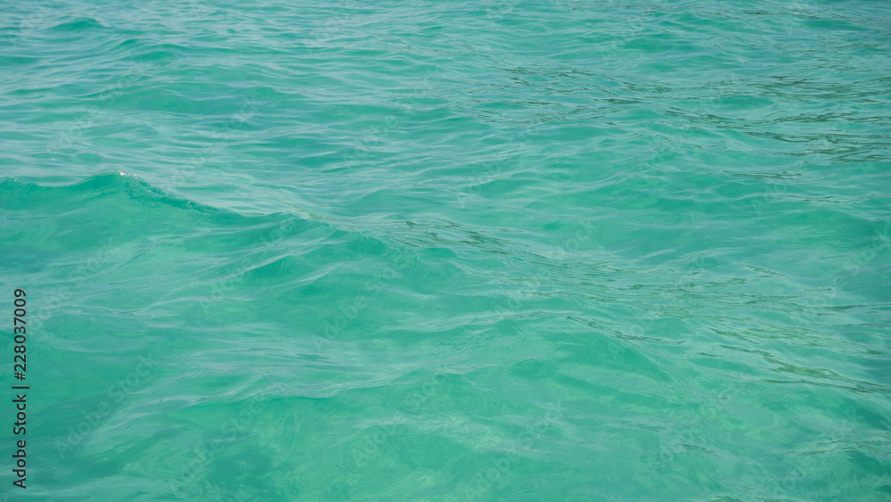 a beautiful green transparent sea on with small ripple wave a beautiful green transparent sea on with small ripple wave