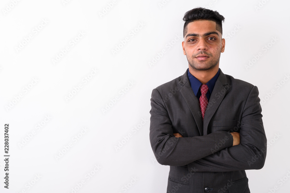 Young Indian businessman wearing suit against white background Young Indian businessman wearing suit against white background