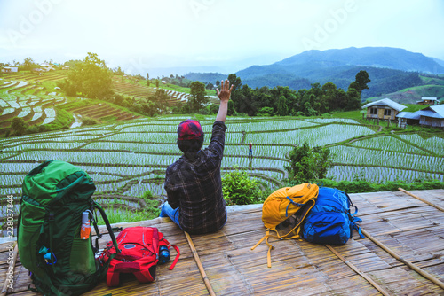 Asian man relax travel nature Viewpoint Rice field the Moutain papongpieng summer in Thailand. photo