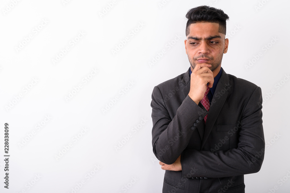 Young Indian businessman wearing suit against white background Young Indian businessman wearing suit against white background