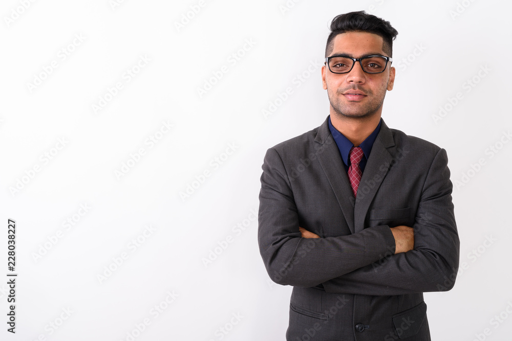 Young Indian businessman wearing suit against white background Young Indian businessman wearing suit against white background