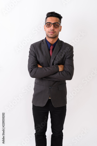 Young Indian businessman wearing suit against white background