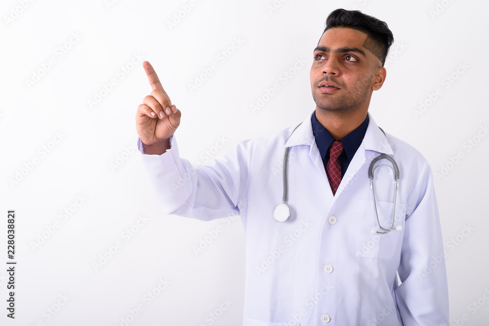 Young Indian man doctor against white background