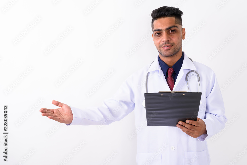 Young Indian man doctor against white background Young Indian man doctor against white background